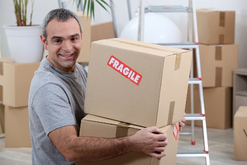Careful loading of furniture into a moving van in Swiss Cottage