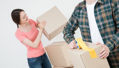Packed office boxes and furniture ready for a business move near Finchley Road