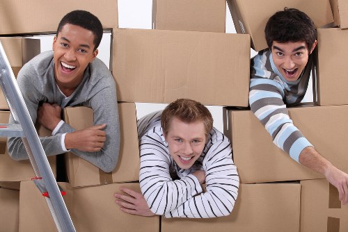 Removal crew handling workplace equipment during a commercial move