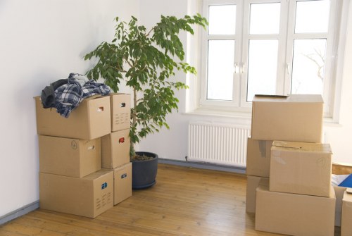 Removalists loading household items into a van in Swiss Cottage