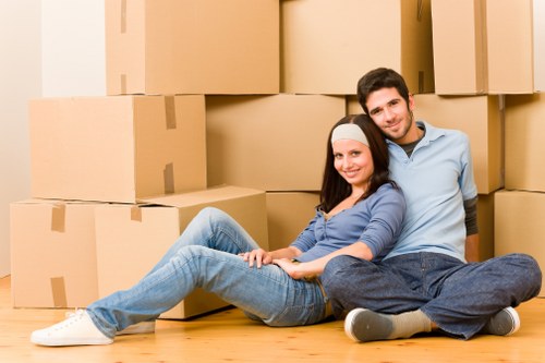 Professional movers handling boxes and furniture in a Swiss Cottage home